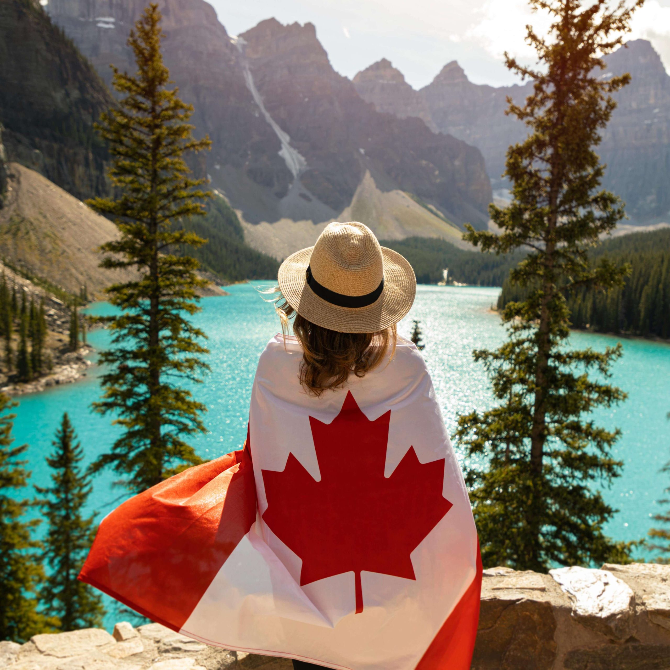 Alberta Immigration Consultant Image: Woman in a Canadian flag in the Rockies